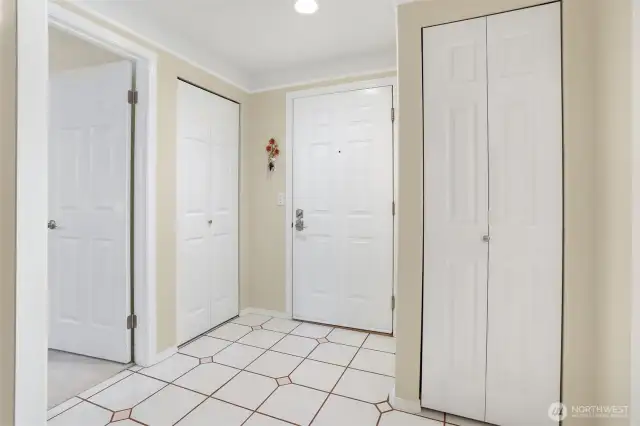 Entry area. DOORS: Left door is to the second bedroom, second door is coat closet, middle door is the entrance, and door to the right is a linen closet.