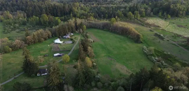 Aerial view of the 39 acres,main home, upper, middle and lower pastures as well as the orchard, old 1920 farmhouse, RV pad, barns, shed and Conex for storage.