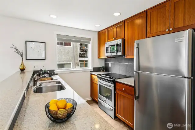 Kitchen has plenty of counter space great storage, and a window.