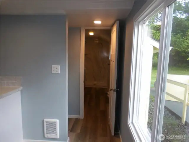 From the kitchen go down the hallway to the washer/dryer hook up laundry area and to the brand new bathroom.