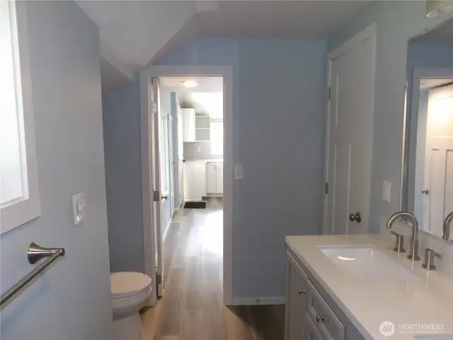 From the shower in the bathroom, straight ahead is the hallway with the w/d hook up just through the door, then int the kitchen.  The open door after the vanity goes into one of the bedrooms.