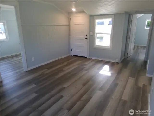 That is the front door.  Door to the left is a bedroom.  Door to the right of front door is the second bedroom with bathroom entry.