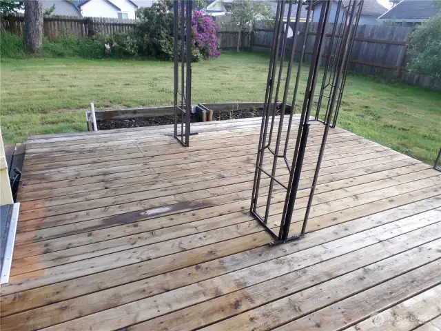 Nice wood deck right outside the kitchen door.  Big and levedl back yard to enjoy.