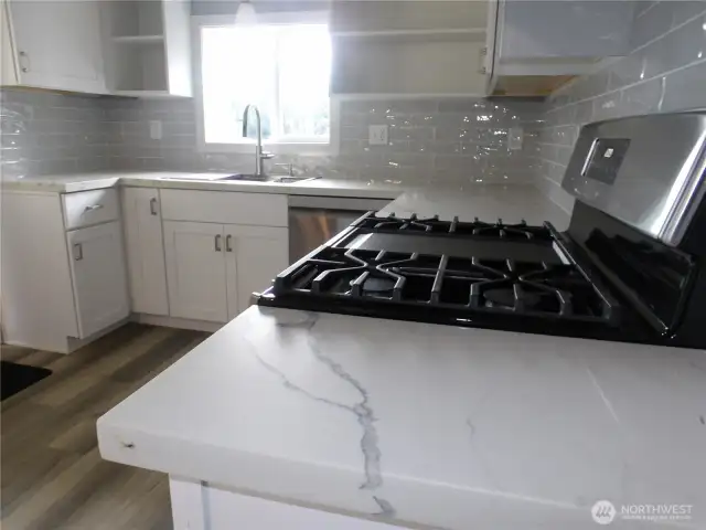 New appliances and quartz in the kitchen.