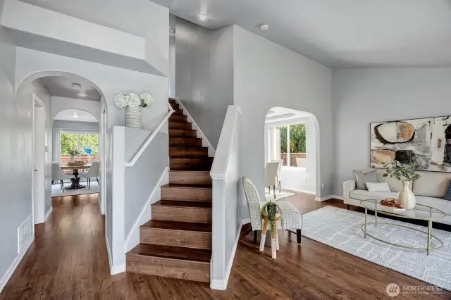 Airy vaulted entry & living space offer a light-filled, welcoming vibe.
