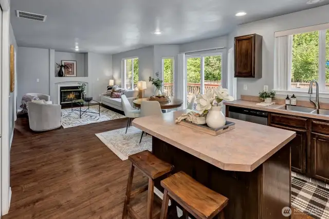 Kitchen flows seamlessly into a spacious room & expansive deck.
