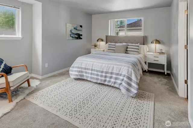 The primary suite features a cozy reading nook, wall-to-wall mirrored double vanity and a walk-in closet.