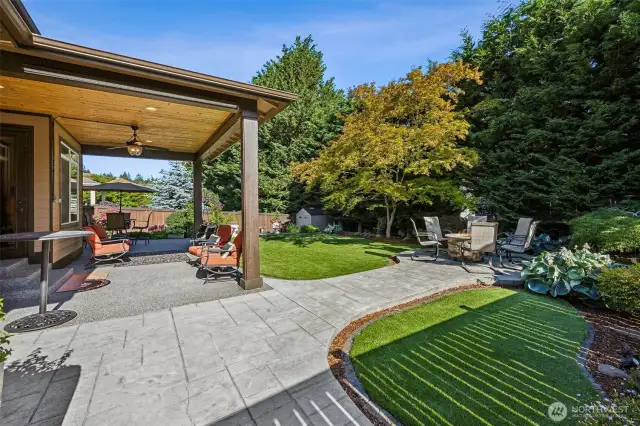 Enjoy effortless outdoor entertaining with a spacious covered patio featuring stamped concrete, low maintenance turf all surrounded by mature landscaping for added privacy. .