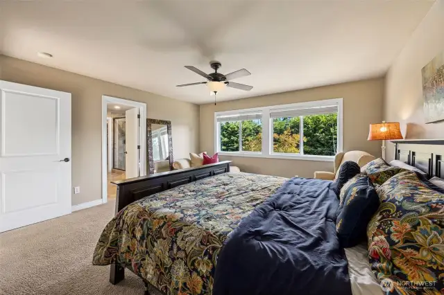 Primary suite featuring a large picture window that fills the room with natural light, plus an attached ensuite bathroom for ultimate comfort and privacy.
