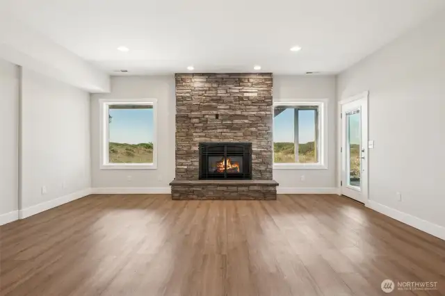 Entry level living room with fireplace and patio access.