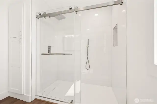 Custom tile shower and added storage in the spacious guest bath.
