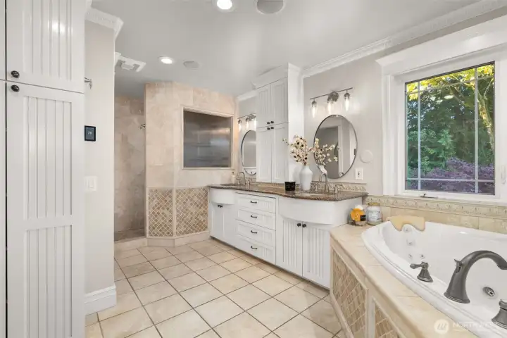 The expansive primary bathroom with dual sinks, a jetted tub, heated floors and more.