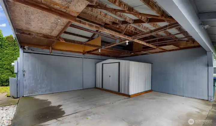 Metal shed conveys (stays) with sale!  There's storage room above and plenty of room for a car/suv and a motorcycle or another small EV