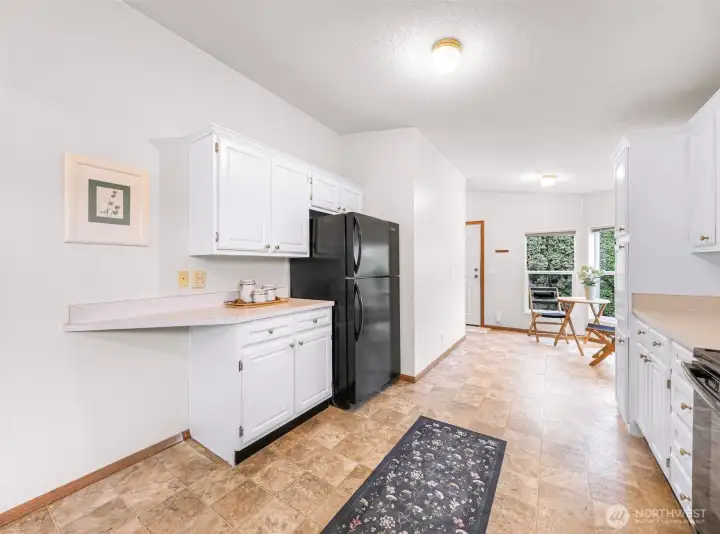 Coffee bar or ? to your left.  Breakfast or serenity nook at the center looking over the fenced back yard.  You decide on where your things need to go.  Flooring is in good shape and the fridge is a big one!