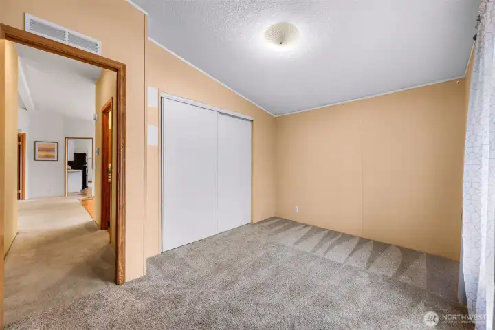 3rd bedroom also has a large closet.  The water heater is also located in the closet, yet not IN the closet space.  You see the hallway to the 2nd bathroom, looking towards the living room and kitchen from here.