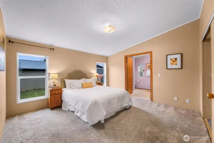 The primary suite is on the opposite side from bedroom #2 and #3 for complete privacy and is HUGE!  Closet doors to your right, bathroom seen at center.