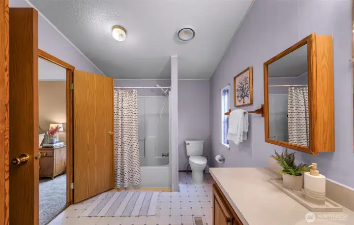 Full bathtub/shower seen here and this bathroom is BIG as well.