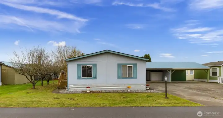 Front view of this home in Mountain Vista Park.  Carport and long, spacious driveway seen to the right.