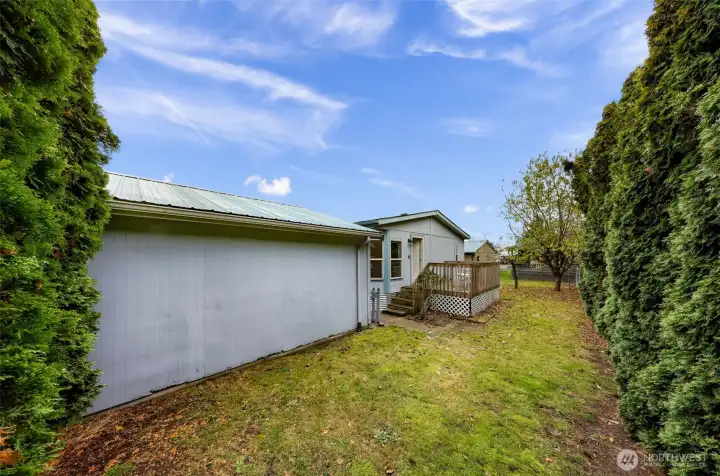 Full view of the nice long back yard that is fenced and feels very private.  Carport/storage building is owned by the Mountain Vista Park.