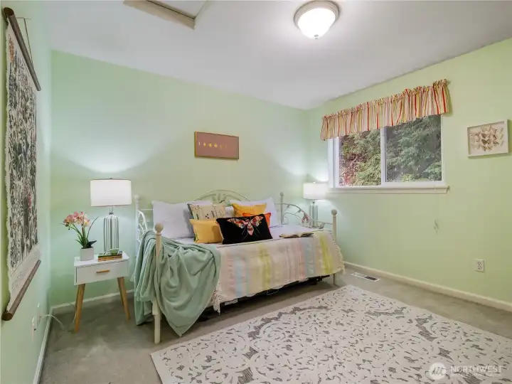 The second bedroom on the top floor has a view of the back yard.