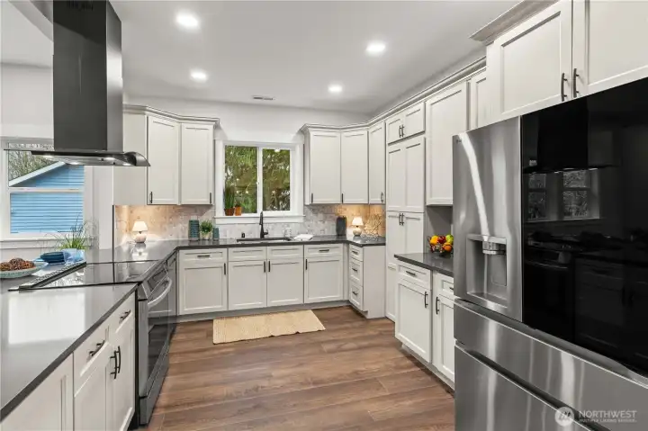 Oooh la la!! Brand New Cabinets, Custom Full Tile Backsplash, Wide-Plank Laminate Floors, Recessed Lighting and Stainless Steel Appliances. The secret butler's pantry is so fun!