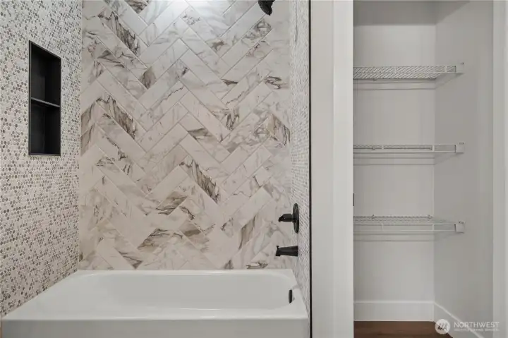 Main Hall Bath Shower w/Custom Tile and Black Accents. Linen Shelving is already in place!