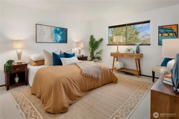 Primary suite with new carpet and dual closets.