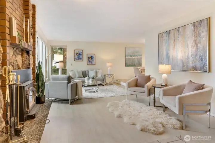 Step inside to a warm and inviting living room, anchored by a cozy fireplace—perfect for relaxing or gathering