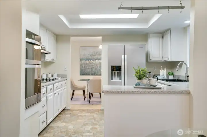 From there, step into the kitchen featuring a new fridge and oven—ready for everyday use and entertaining