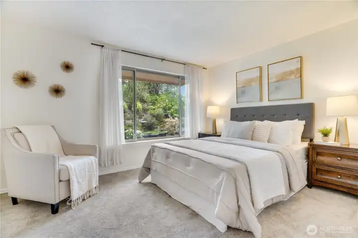 The main level bedroom provides versatile space, perfect for guests, remote work, or evolving lifestyle needs