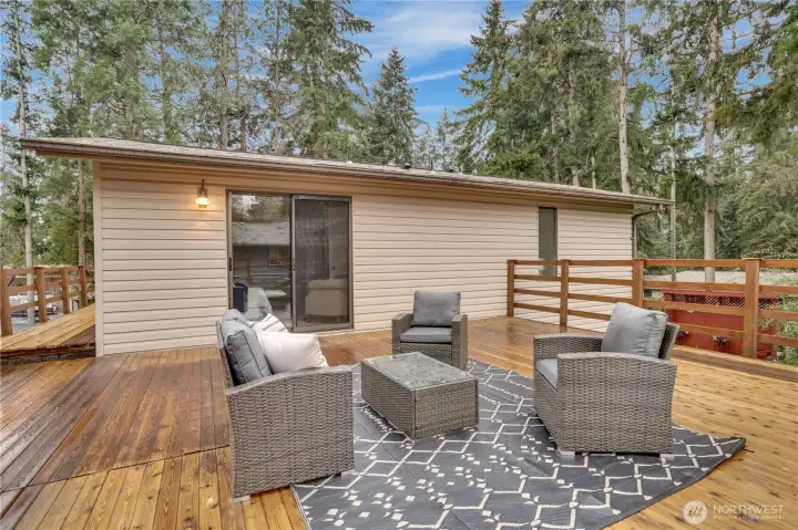 Just off the primary bedroom, a stunning 700 sq ft deck offers the perfect space for morning coffee, evening unwinding, or entertaining under the open sky