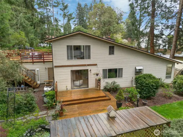 The backyard feels like a private oasis, complete with a tranquil pond and deck, perfect for relaxing or entertaining