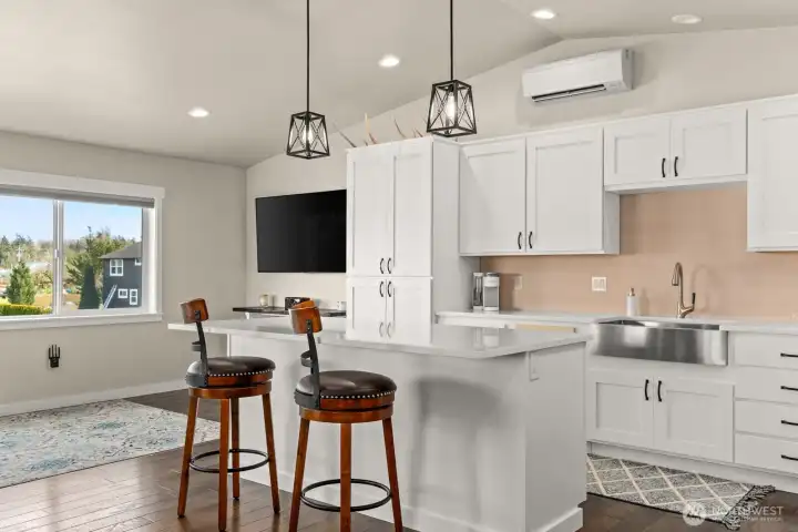 Living room/Kitchen with island and bar above shop