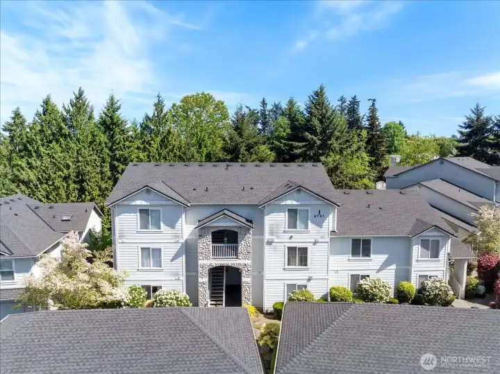 Nestled in a quiet, tree-lined community surrounded by single-family homes, this ground-floor condo offers a peaceful residential setting.