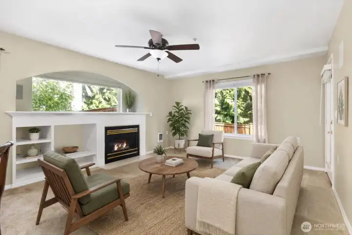 The spacious open-concept living room creates an inviting space for both relaxing and entertaining.  Large windows fill the room with natural light throughout the day.[Photo is virtually staged.]
