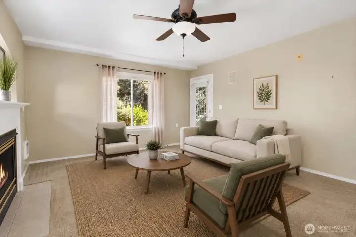 This living space offers the comfort and feel of a detached home without the maintenance. Large windows and glass fronted patio door fill the room with natural light throughout the day.    [Photo is virtually staged.]