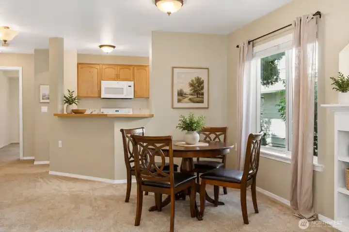 The adjacent dining space is ideal for casual meals or hosting guests.    [Photo is virtually staged.]