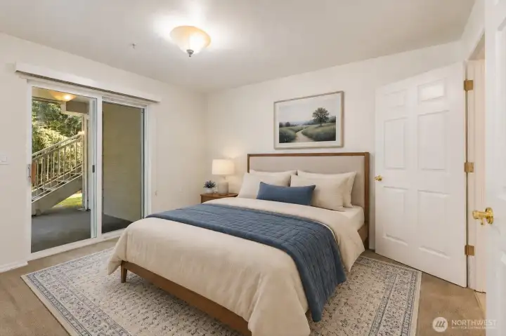 The spacious primary suite offers a comfortable and private retreat. Step directly outside to enjoy quiet mornings with coffee or peaceful evening relaxation. [Photo is virtually staged.]