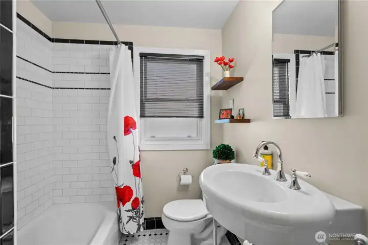 Main Floor Bath w/Updates that speak to the character of the home. Tile Surround Shower and Floors.