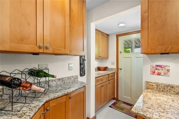 Cabinets continue to 'Mud Room' doorway to Backyard.