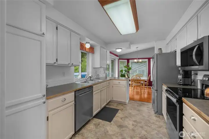 The galley-style kitchen provides excellent storage, efficient workflow, and convenient access to indoor and outdoor dining The galley-style kitchen provides excellent storage, efficient workflow, and convenient access to indoor and outdoor dining