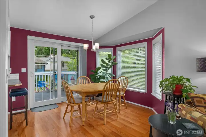 Bright dining area features abundant natural light, bay windows, and direct access to the deck for easy indoor-outdoor living Bright dining area features abundant natural light, bay windows, and direct access to the deck for easy indoor-outdoor living