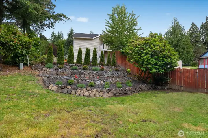 Beautifully landscaped multi-tiered hillside flowerbed creates stunning curb appeal and a welcoming outdoor setting Beautifully landscaped multi-tiered hillside flowerbed creates stunning curb appeal and a welcoming outdoor setting
