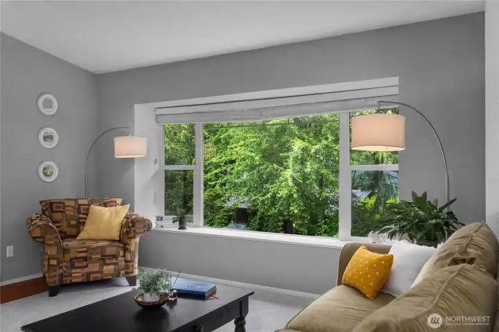 Expansive front-facing window creates a bright, inviting living space with pleasant neighborhood views Expansive front-facing window creates a bright, inviting living space with pleasant neighborhood views