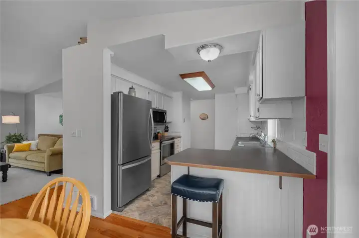 Functional kitchen features a convenient breakfast bar, ample counter space, and easy access to the dining and living areas Functional kitchen features a convenient breakfast bar, ample counter space, and easy access to the dining and living areas