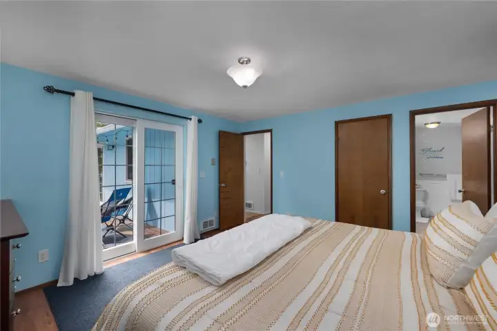 Spacious primary bedroom combines comfort and convenience with deck access and nearby full bath Spacious primary bedroom combines comfort and convenience with deck access and nearby full bath