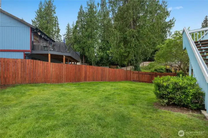 Private backyard oasis featuring mature trees, fresh lawn, and ample space for recreation and relaxation Private backyard oasis featuring mature trees, fresh lawn, and ample space for recreation and relaxation