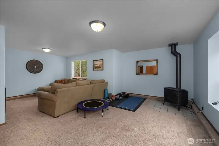 The versatile family room offers generous space and a cozy propane stove for year-round comfort The versatile family room offers generous space and a cozy propane stove for year-round comfort