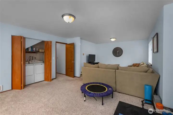 Lower-level living space offers room to spread out, entertain, and enjoy convenient access to the laundry area Lower-level living space offers room to spread out, entertain, and enjoy convenient access to the laundry area