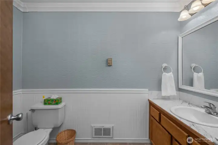 Ground-floor powder room features a refreshed vanity and attractive decorative details Ground-floor powder room features a refreshed vanity and attractive decorative details
